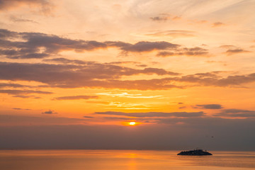 Natural Sunset Sunrise Over Field Or Meadow. Bright Dramatic Sky And Dark Ground. Countryside Landscape Under Scenic Colorful Sky At Sunset Dawn Sunrise. Sun Over Skyline, Horizon. Warm Colours.