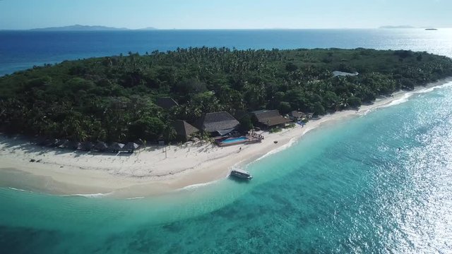Aerial pull shot, flying away from the Resort in Serenity Island in Fiji