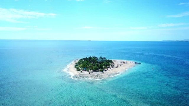 Orbital drone shot of South Sea Island in Fiji on a Sunny Day. Beautiful destination for holiday.