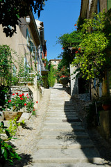 Fototapeta premium street and stairs of mediterranean village with stone wall