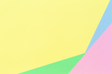 Abstract geometric paper background in light pastel yellow, blue, green, pink color tones