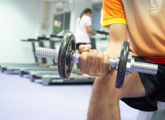 Close up hand holding dumbbell in fitness.