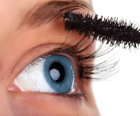 Woman eye with mascara brush