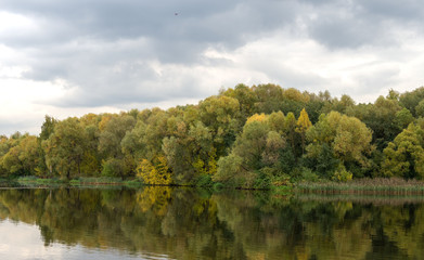 Fototapeta na wymiar Autumn, river, trees, foliage, clouds.