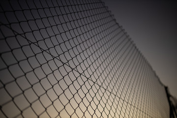 wire fence at sunset with unfocused background