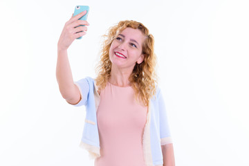 Portrait of happy beautiful blonde woman taking selfie