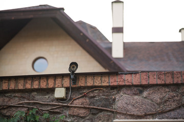 Surveillance video camera on background of modern building