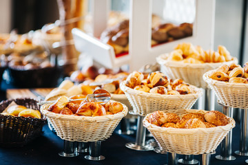 portions of mousse creamy desserts with chocolate. various snacks in three-storey services. Sweets, saltwater, cheese  balls, pickles, cheese tree, chocolate mousse, served on trays