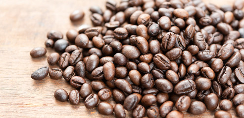 Roasted coffee beans on grunge wood table background