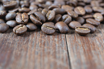 Roasted coffee beans on grunge wood table background