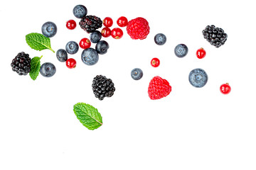 Falling wild berries mix isolated on white background, top view. Strawberry, Raspberry, Blueberry and Mint leaf.