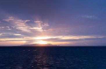 Beautiful beach sunset with big rain clouds and golden light sky  background