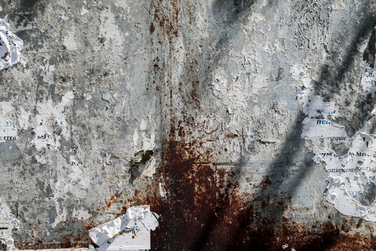 Rusty white wall with paper leftovers, background with space for text