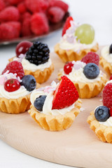 Colorful cupcakes with fresh fruits.