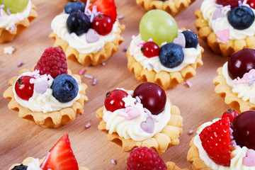 Colorful cupcakes with fresh fruits.