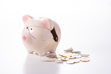 割れた貯金箱と硬貨