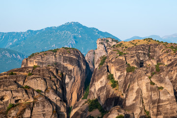 Aerial view of a slide from a drone on a panorama of a mountain range. Kalampaka city, Greece. View of the cliffs of Meteora and the monasteries of Meteora. Many ancient Orthodox monasteries