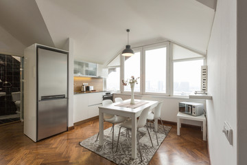 Kitchen interior with dining area in loft apartment