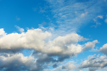 Background of blue sky with dramatic rain clouds.