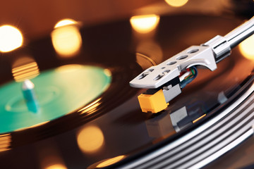 Turntable player with background of a stack of audition records and a Christmas tree. Sound...