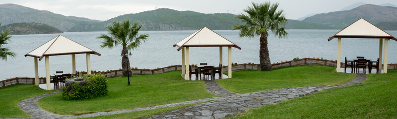 Summer pavilions in the garden with relaxing lake view. Exterior design