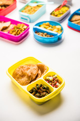 Fototapeta na wymiar group of Lunch Box / Tiffin for Indian kids, showing variety or multiple option or combination of healthy food for your school going children