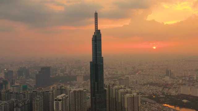 Top View of Building in a City - Aerial view Skyscrapers flying by drone of Ho Chi Mi City on sunset with building , transportation, energy power 