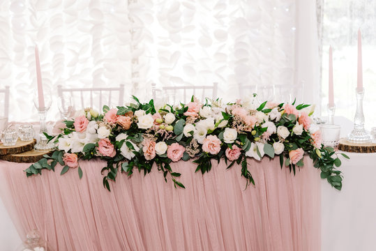 Luxurious and large composition of fresh flowers. Pink and white eustoma on the wedding table.