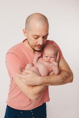 Dad holds the baby in his arms. The concept of educating the father of young children, Happy childhood, a friendly family.