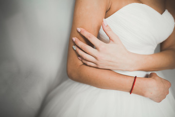 Fototapeta na wymiar Luxury bride in white dress posing while preparing for the wedding ceremony