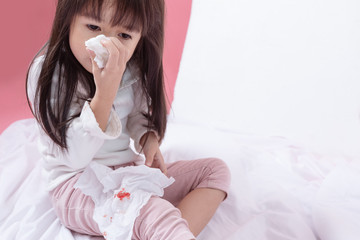 Young Asian girl wipe blood from his nose and the grandmother is hands take care