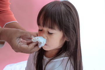 Young Asian girl wipe blood from his nose and the grandmother is hands take care