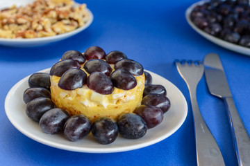 The legendary Tiffany layered salad with grapes, chicken and cheese on the blue background.