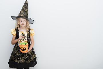 Front view little girl in witch costume for halloween