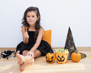Front view little girl sitting on floor on halloween