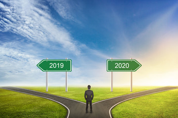 Businessman Concept of choose the correct way. Between 2019 or 2020 years.