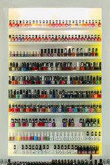 Fototapeta premium NAKHONRATCHASIMA, THAILAND SEP 01, 2019: Set of different nail varnishes on shelves in cosmetic store.