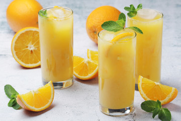 Glasses full of orange juice with ice