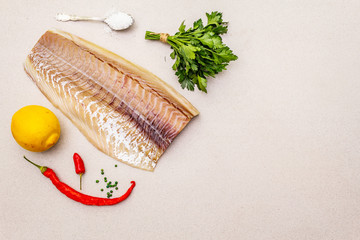 Raw cod loin fillet with lemon, sea salt, chili and cayenne pepper, parsley