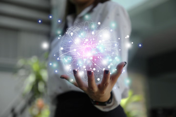 Close up of business woman hands showing digital planet technology.