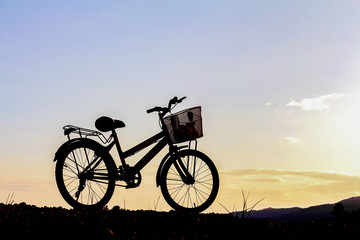 Fototapeta na wymiar bike on the mountain sunset background