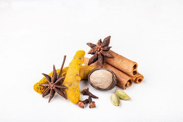 Dry warming Indian spices for autumn and winter meal on white concrete background.