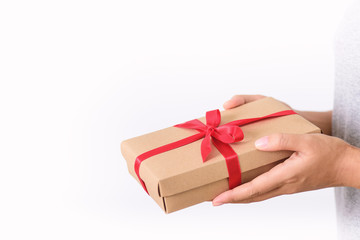 Gift box in hand for giving on white background