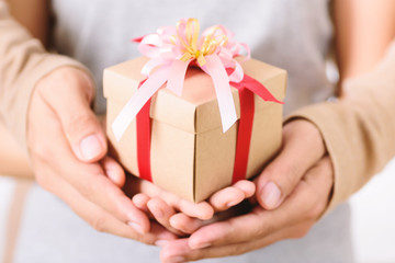 Couple hand holding gift box together, happy and love moment