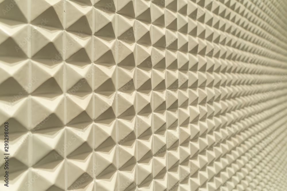 Poster triangle pyramid tiles pattern surface texture. close-up of architecture interior material for desig