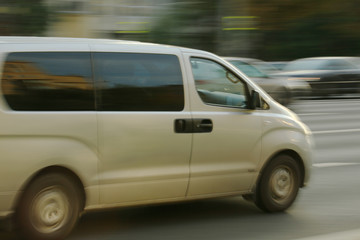 Fototapeta na wymiar light van moving around the city. blur