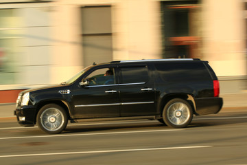 Obraz na płótnie Canvas dark car in motion around the city. blur