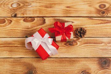 Small christmas gifts on wooden background, view from above