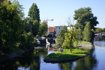 Obraz premium Bydgoszcz, Poland - September 2019: View of the city water canal of the Brda River in the city center. City architecture.