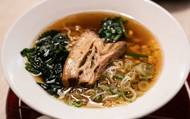 Delicious Japanese ramen noodles with pork, and seaweed on bowl.